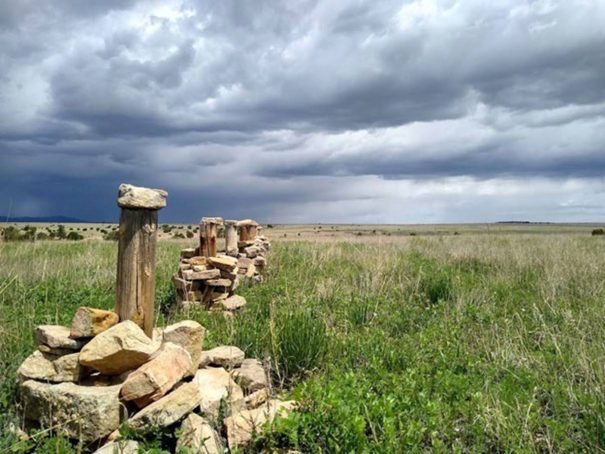 photo of a prairie with a stormy sky